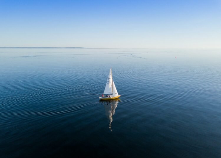 sailboat calm sea sunrise