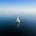 sailboat calm sea sunrise