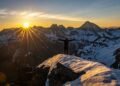 snowy mountain sunrise hiker