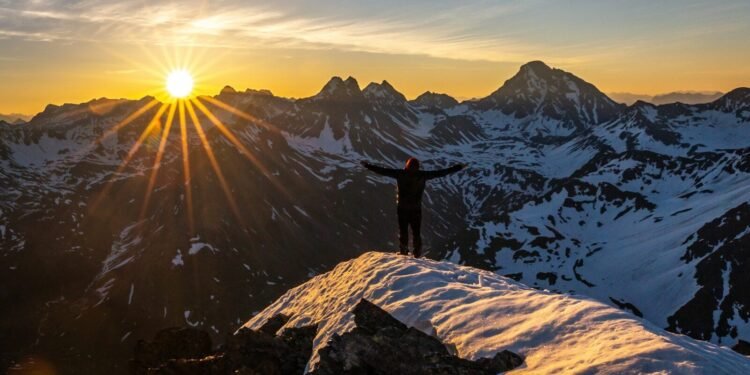 snowy mountain sunrise hiker