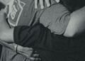 A group of men in a team hug
