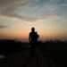 A silhouette of a man running at sunset