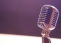A vintage silver microphone with blue accents