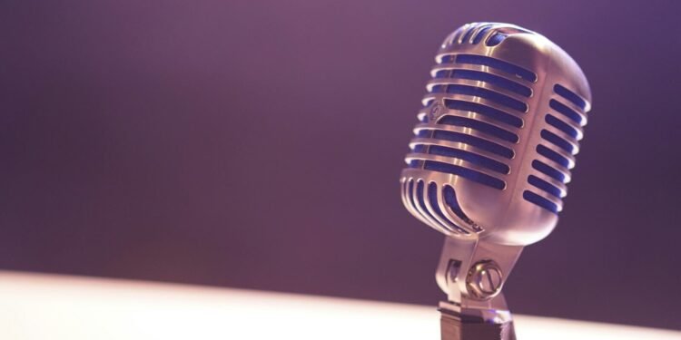 A vintage silver microphone with blue accents