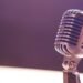 A vintage silver microphone with blue accents