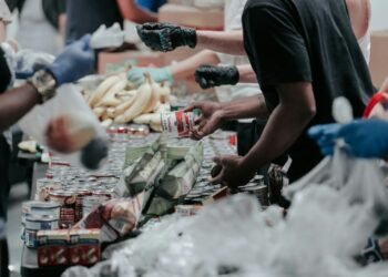 volunteers handing groceries box