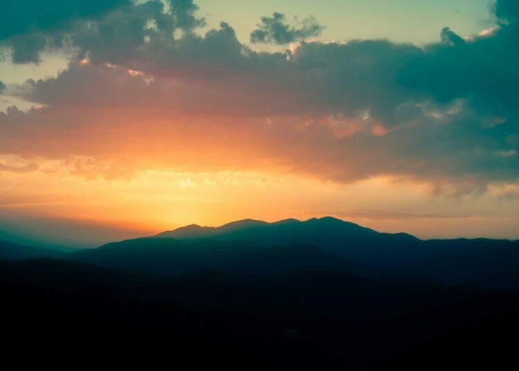 silhouette of mountains during sunset